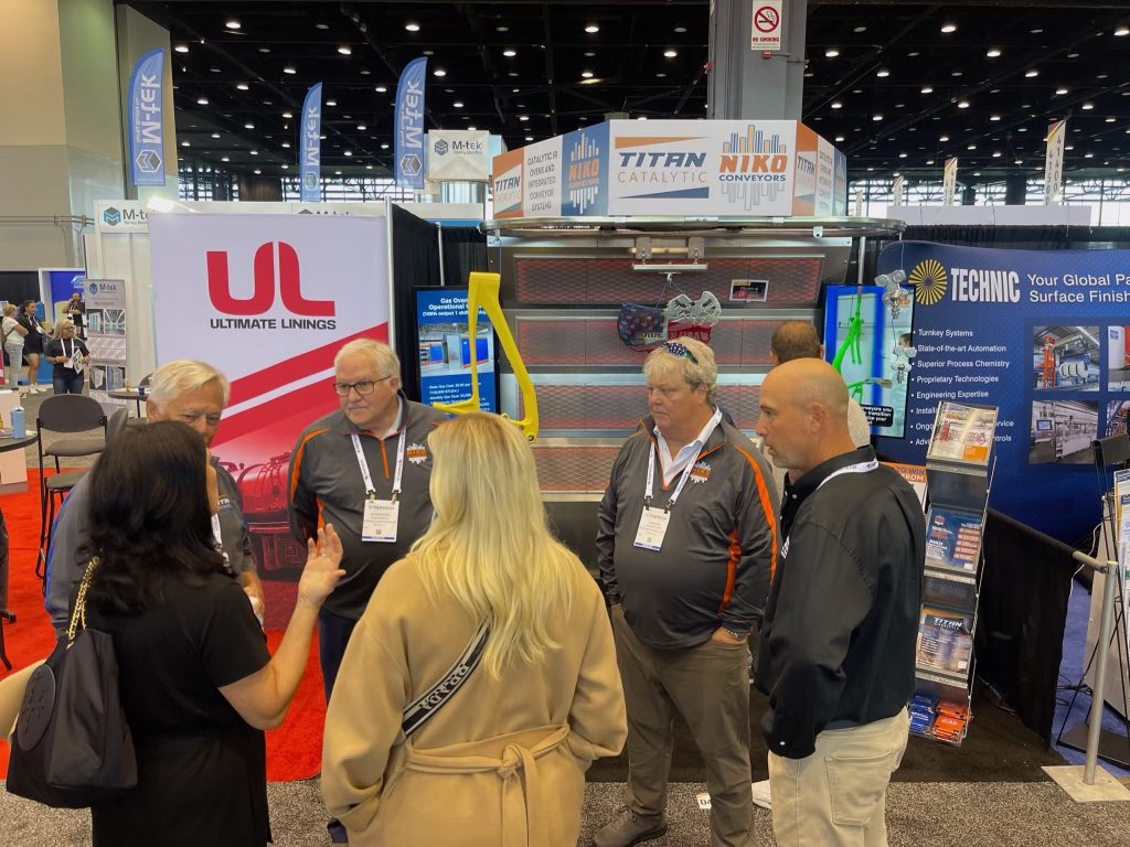 Fabtech Chicago booth colleagues and clients discussing equipment